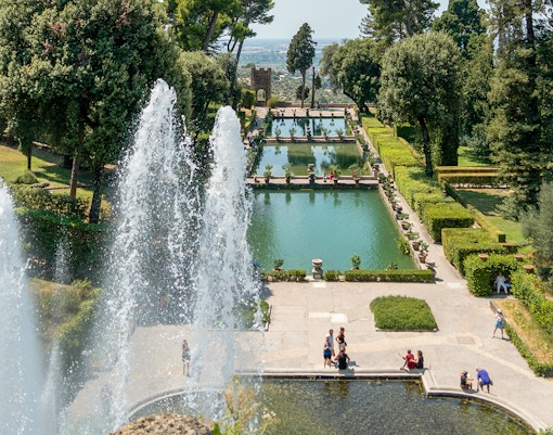 Tourists enjoying the fountains and gardens of Villa d'Este in Tivoli, Italy.