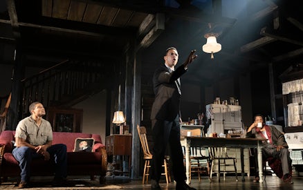 Performance scene from "The Piano Lesson" with actors in a living room setting.