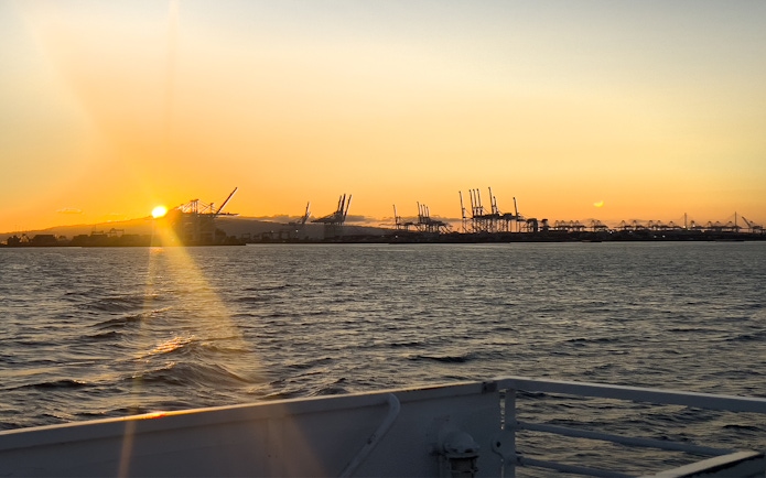 Sunset view of cranes at Los Angeles Harbor from a sightseeing cruise.