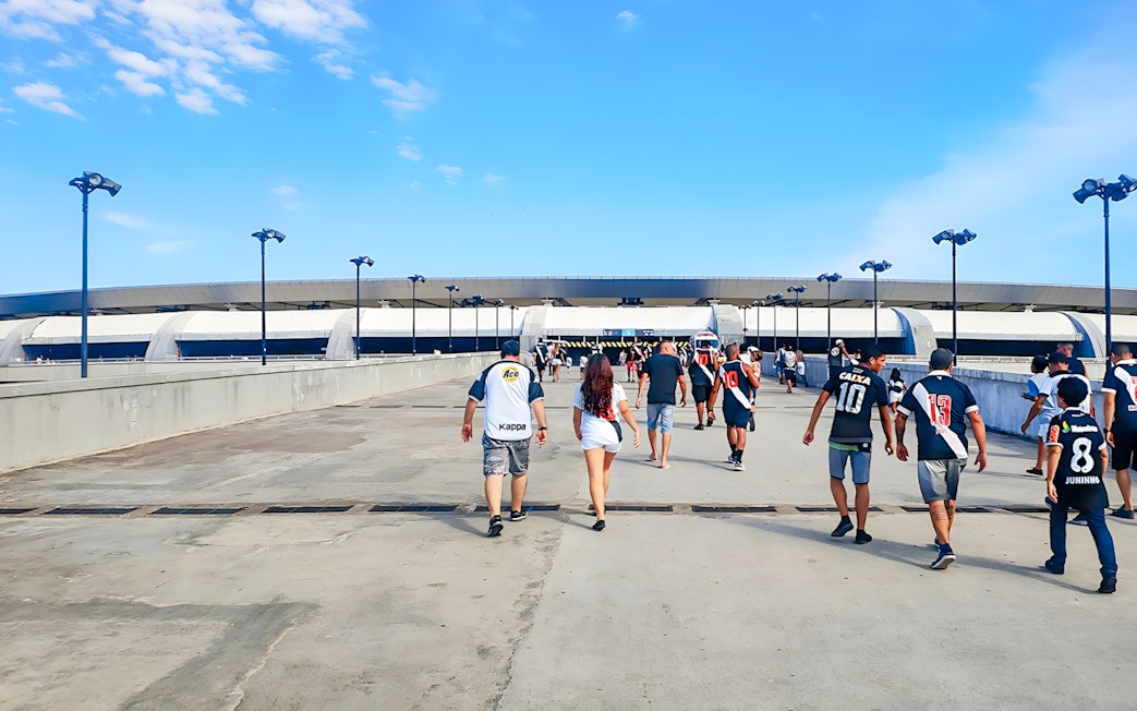 Tourists walking towards Maracanã Stadium entrance in Brazil.