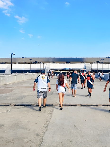 Tourists walking towards Maracanã Stadium entrance in Brazil.