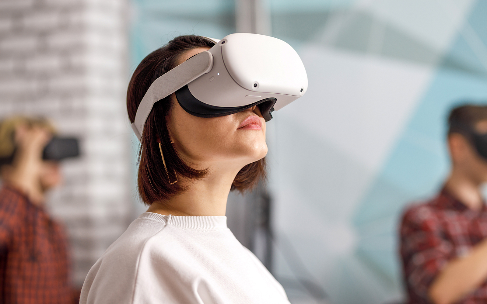 Person wearing VR goggles in a modern indoor setting.