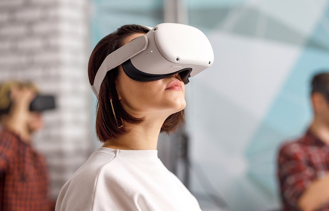 Tourists enjoying a VR experience at Habitat Penang Hill, Malaysia, surrounded by lush greenery