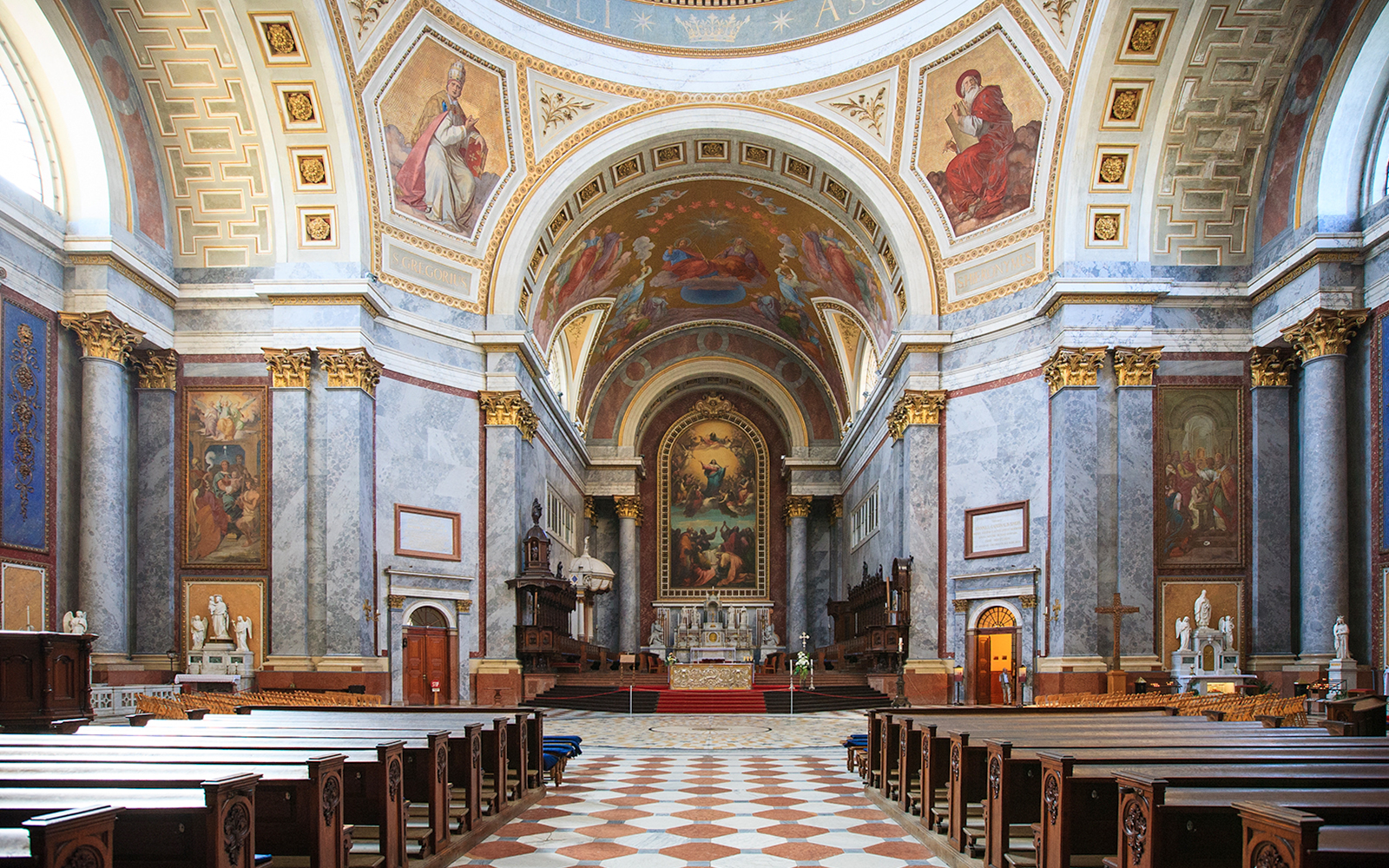 Interior view of the Basilica of St. Adalbert in Esztergom, featuring ornate frescoes and grand architecture.