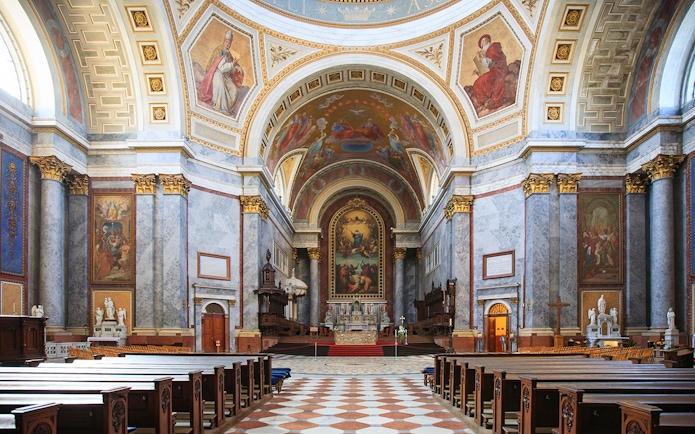 Interior view of the Basilica of St. Adalbert in Esztergom, featuring ornate frescoes and grand architecture.