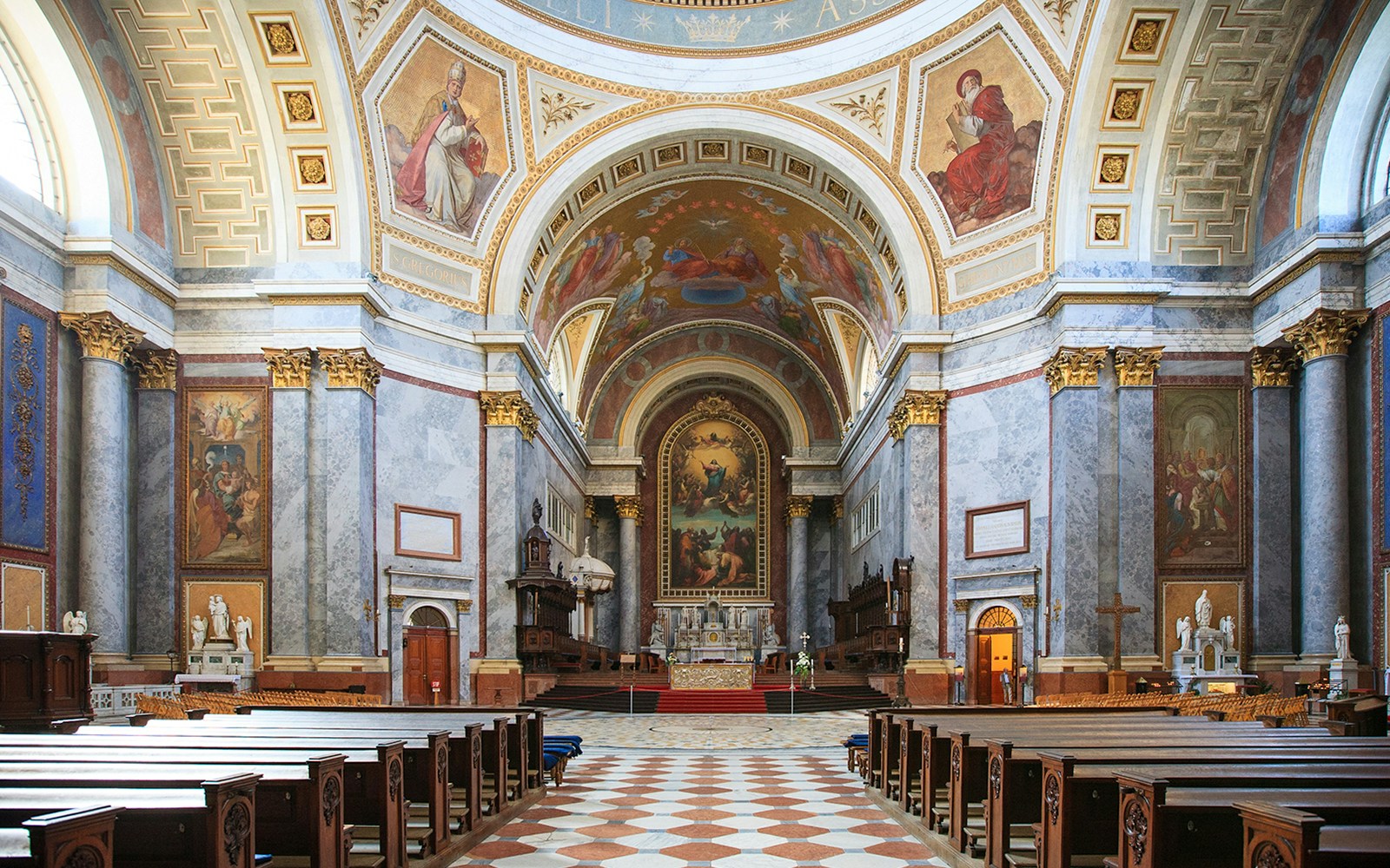 Interior view of the Basilica of St. Adalbert in Esztergom, featuring ornate frescoes and grand architecture.