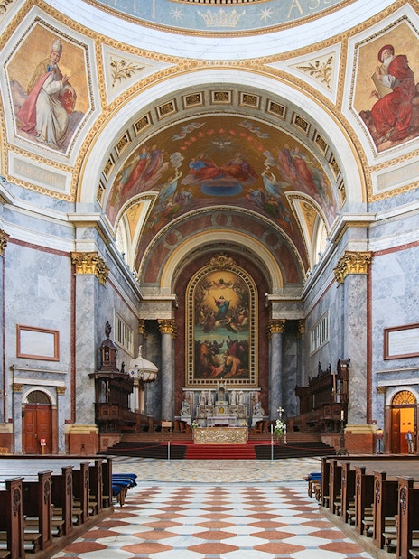 Interior view of the Basilica of St. Adalbert in Esztergom, featuring ornate frescoes and grand architecture.