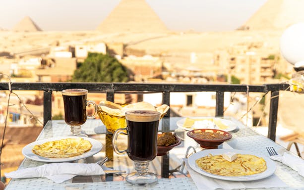 Breakfast with coffee overlooking the Pyramids in Cairo on a private half-day tour.