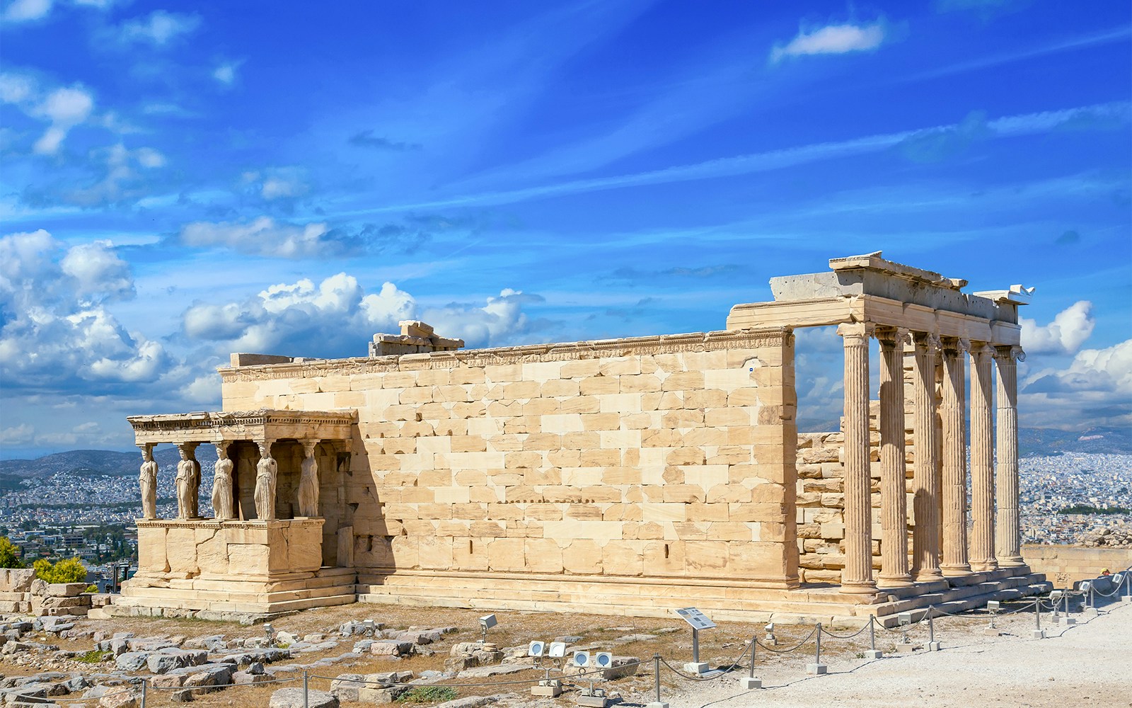 Ancient Erechtheion with Caryatid Porch on the Acropolis, Athens, Greece, showcasing iconic columns.