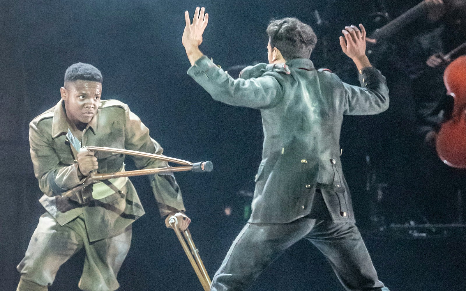 Actors in military attire perform a dramatic scene in "Peaky Blinders: The Redemption of Thomas Shelby.