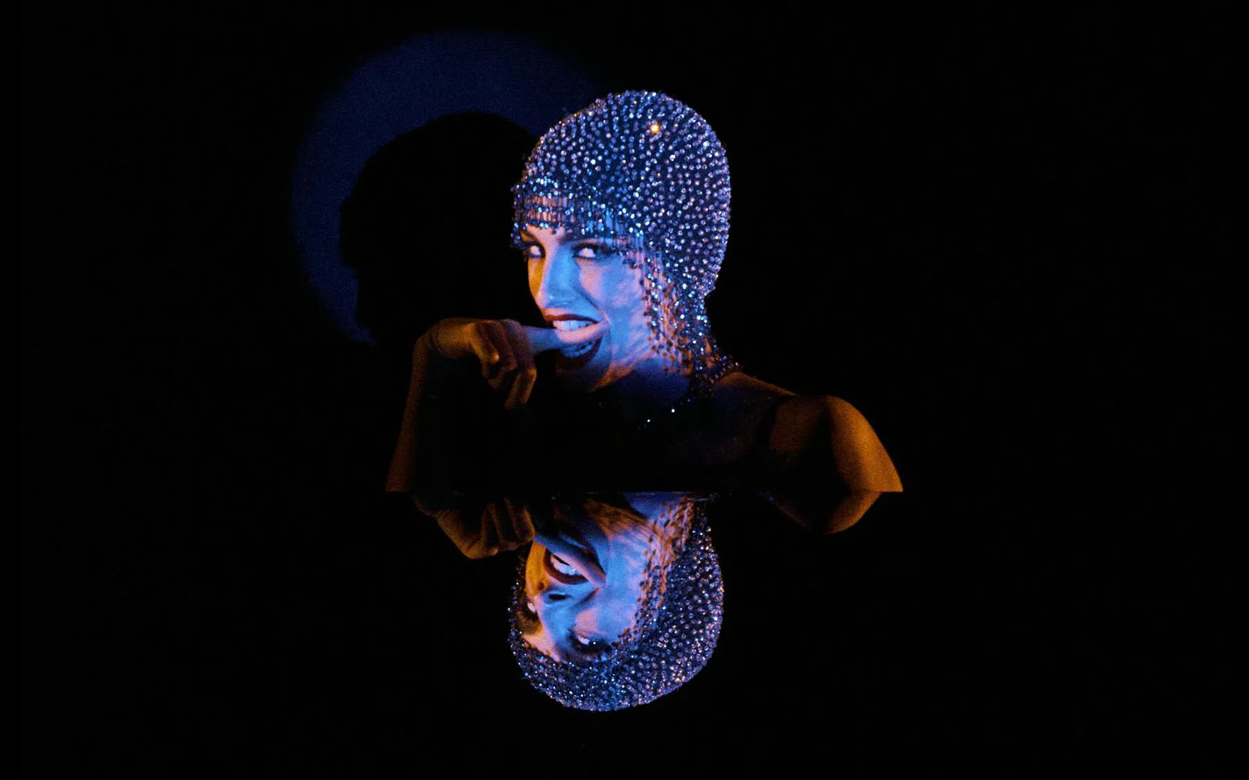 Performer in sparkling headpiece at Crazy Horse Paris - The Dubai Edition, Dubai.