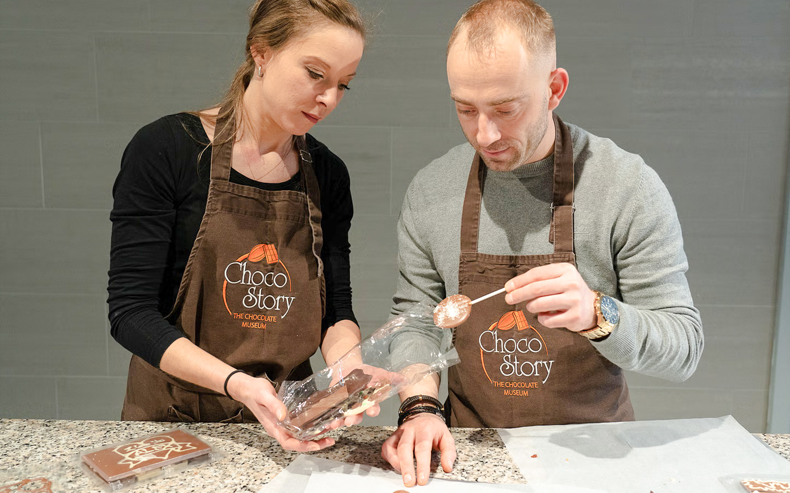 Host demonstrating chocolate making at Choco-Story Brussels Museum.