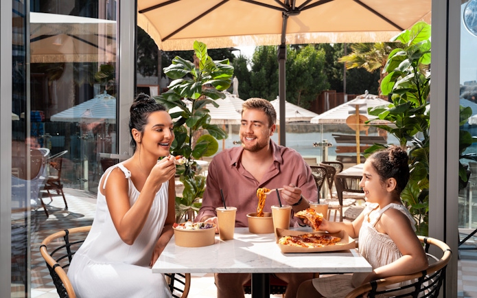 Family enjoying lunch at Grand Hyatt waterpark, Dubai.