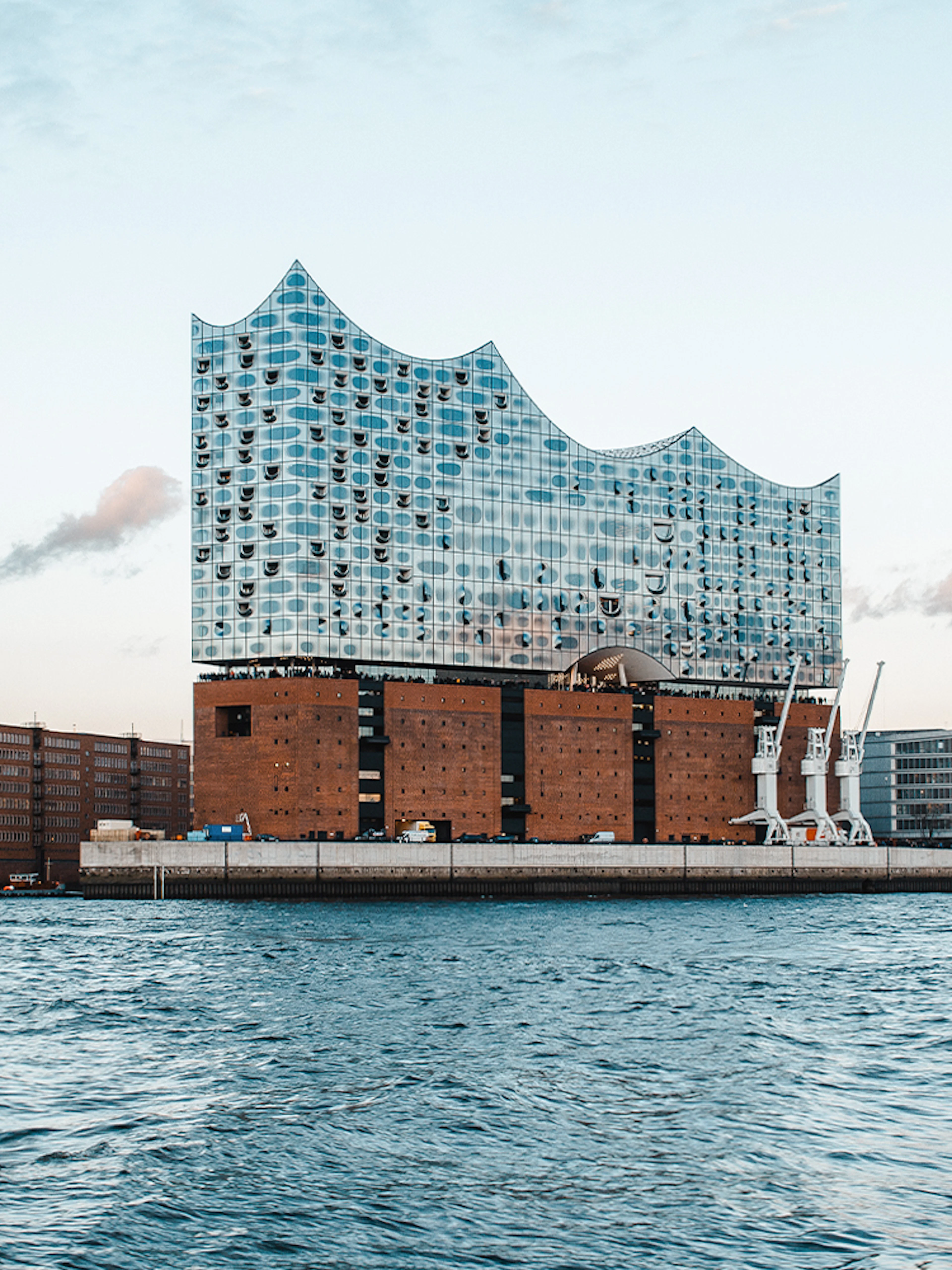 Elbphilharmonie building exterior in Hamburg, viewed from the water.