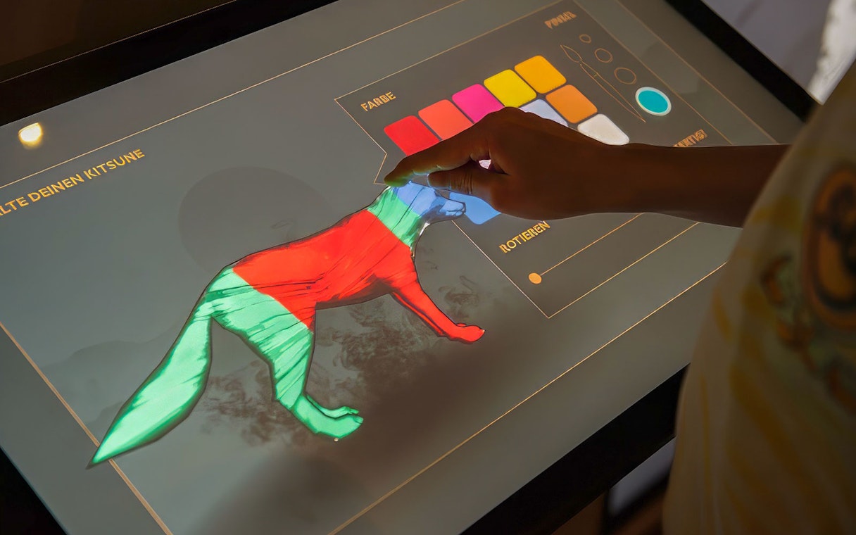 Interactive display at Samurai Museum for designing a kitsune with color options.