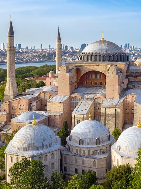 Hagia Sophia in Istanbul with minarets and city skyline in the background.