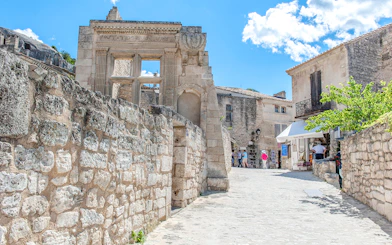 Ancient stone buildings and narrow street in Les Baux de Provence, France.