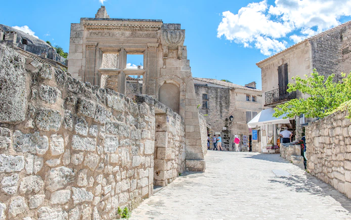 Ancient stone buildings and narrow street in Les Baux de Provence, France.