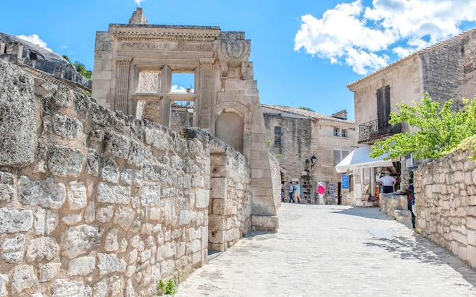 Ancient stone buildings and narrow street in Les Baux de Provence, France.