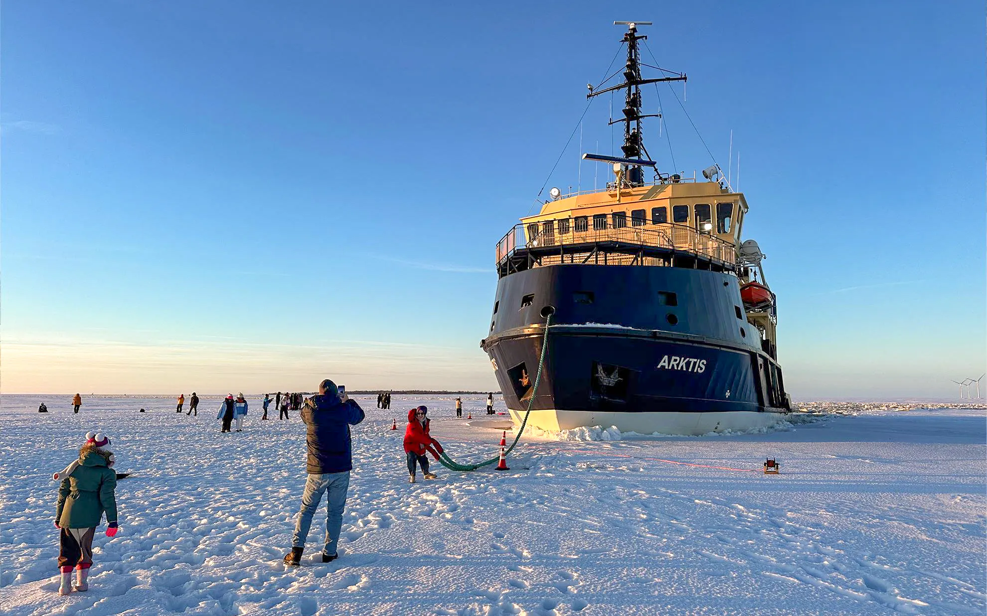 Icebreaker Arktis on frozen sea with tourists, Kemi cruise experience.