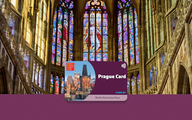Prague Card displayed against stained glass windows in a historic cathedral.