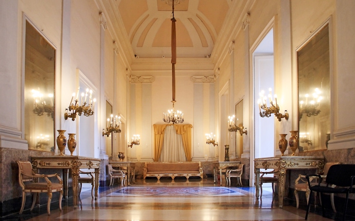 Royal Palace of Naples historic apartment with chandeliers and ornate furniture.