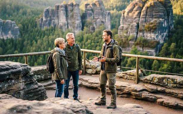 Tour guide explaining to guests during Saxon & Bohemian Switzerland Day Trip with rock formations in background.