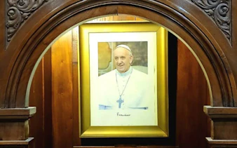 Wooden confessional with a framed portrait inside Basílica de San José de Flores, Buenos Aires.