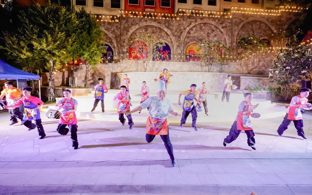 Performers in colorful costumes dancing at Sun World Hon Thom.