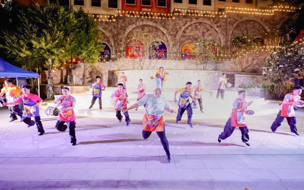Performers in colorful costumes dancing at Sun World Hon Thom.