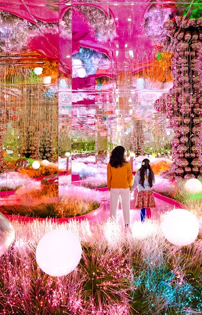 Visitors exploring a vibrant, mirrored art installation at House of Hype.