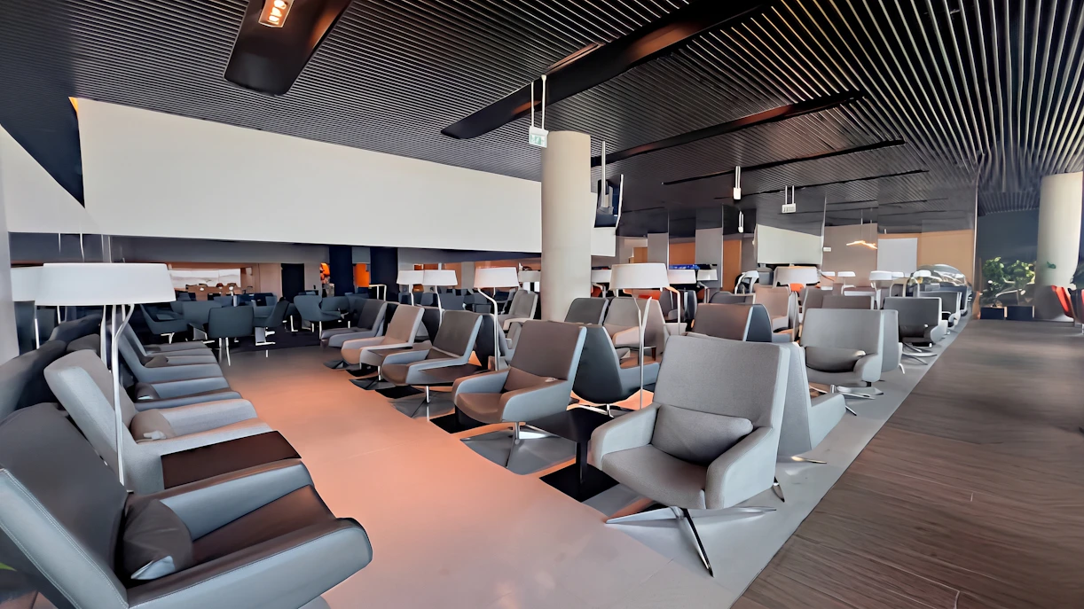 ANA Lounge seating area at Lisbon Airport with modern chairs and ambient lighting.