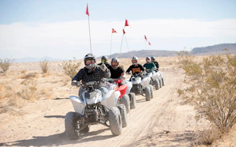 ATV riders on sand dunes during Las Vegas guided tour with off-road terrain.