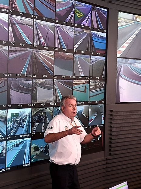 Guide explaining Yas Marina Circuit control room with multiple track monitors.