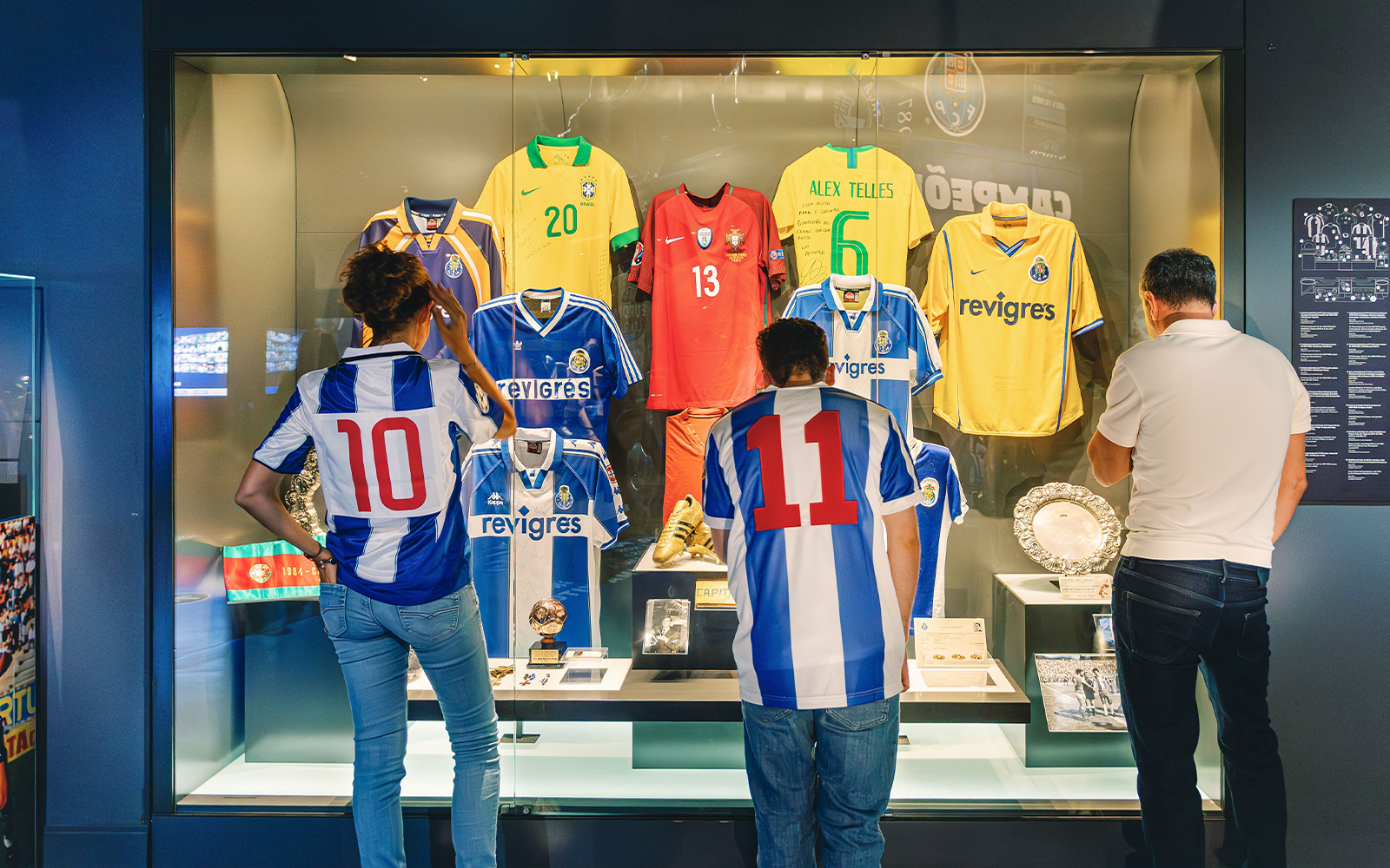 Visitors at FC Porto stadium museum viewing historic jerseys display.