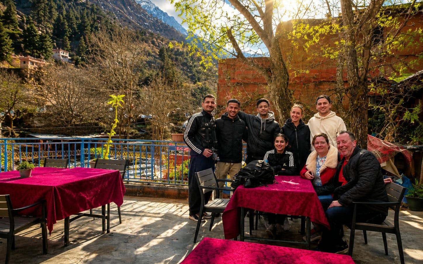 Group enjoying lunch on a terrace in Ourika Valley, Atlas Mountains, Marrakech.