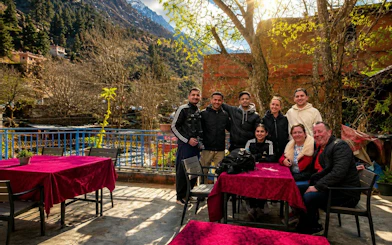 Group enjoying lunch on a terrace in Ourika Valley, Atlas Mountains, Marrakech.