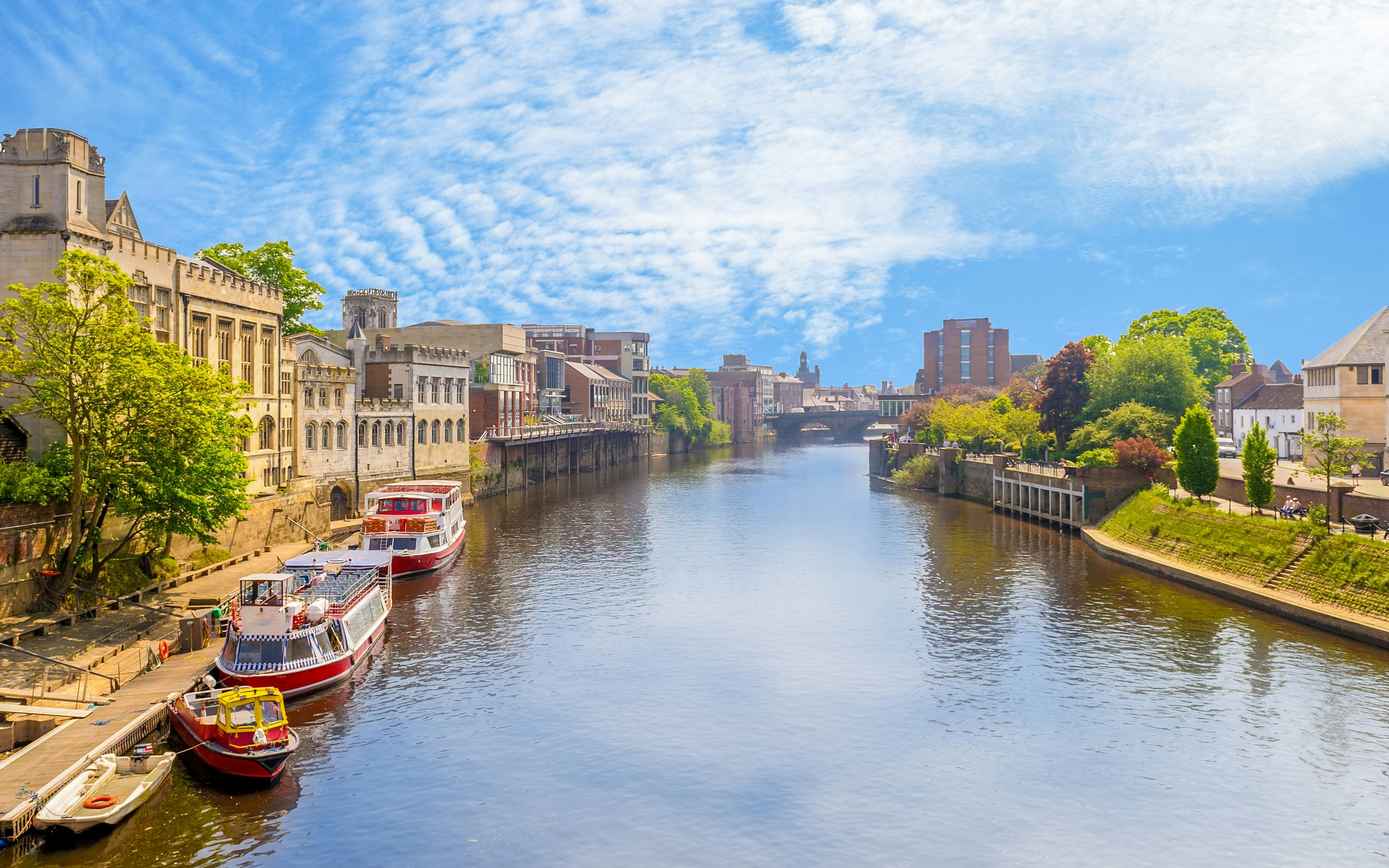 River Ouse in York with boats docked along the historic riverbank.