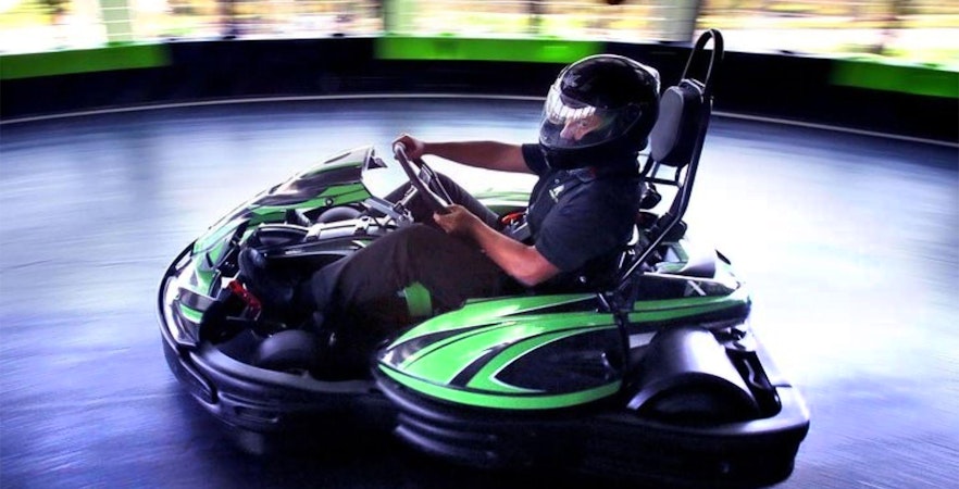 Person driving a go-kart at Andretti Indoor Kart Racing in Orlando.
