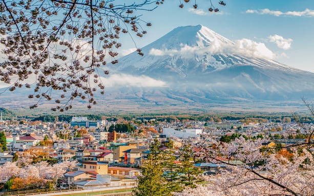 Fujiyoshida City with cherry blossoms and Mt Fuji in the background.