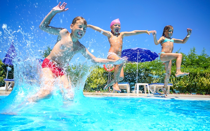 Children jumping into a pool at Ramayana Water Park, Thailand.