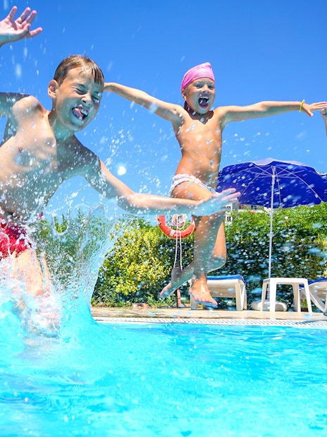 Children jumping into a pool at Ramayana Water Park, Thailand.