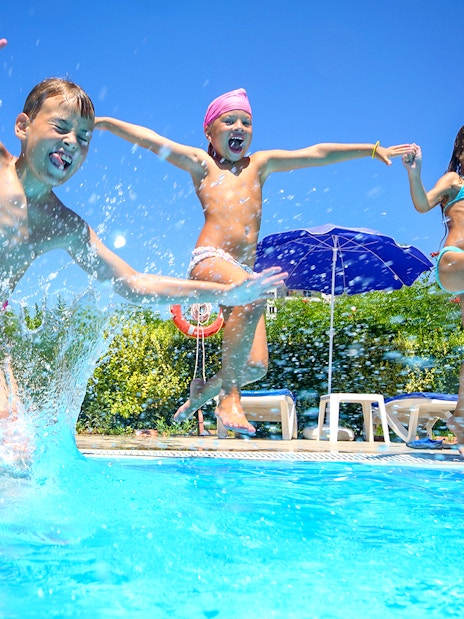 Children jumping into a pool at Ramayana Water Park, Thailand.