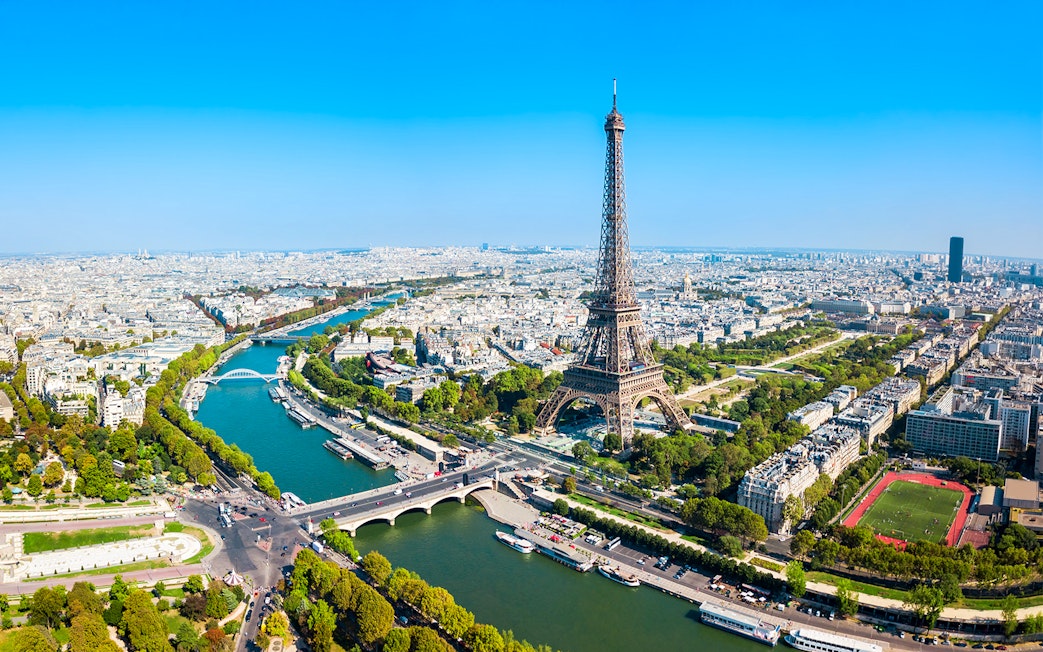 Eiffel Tower view over Paris with Seine River, ideal for elevator tour to summit or second floor.