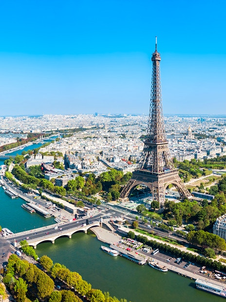 Eiffel Tower view over Paris with Seine River, ideal for elevator tour to summit or second floor.