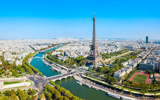 Eiffel Tower view over Paris with Seine River, ideal for elevator tour to summit or second floor.