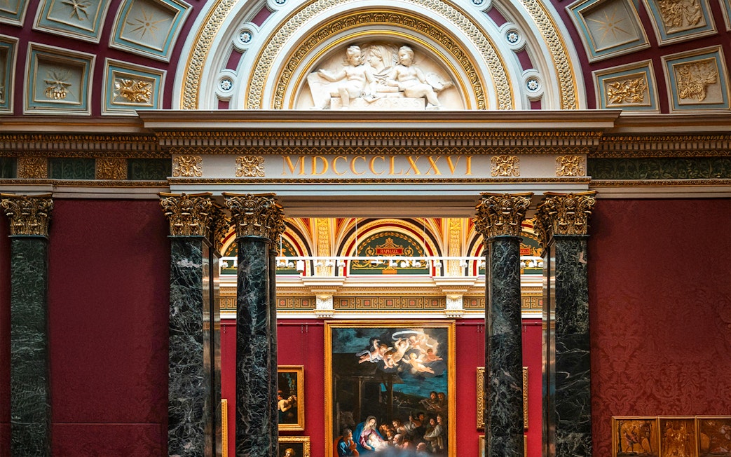 National Gallery London interior with classic European paintings and ornate architecture.