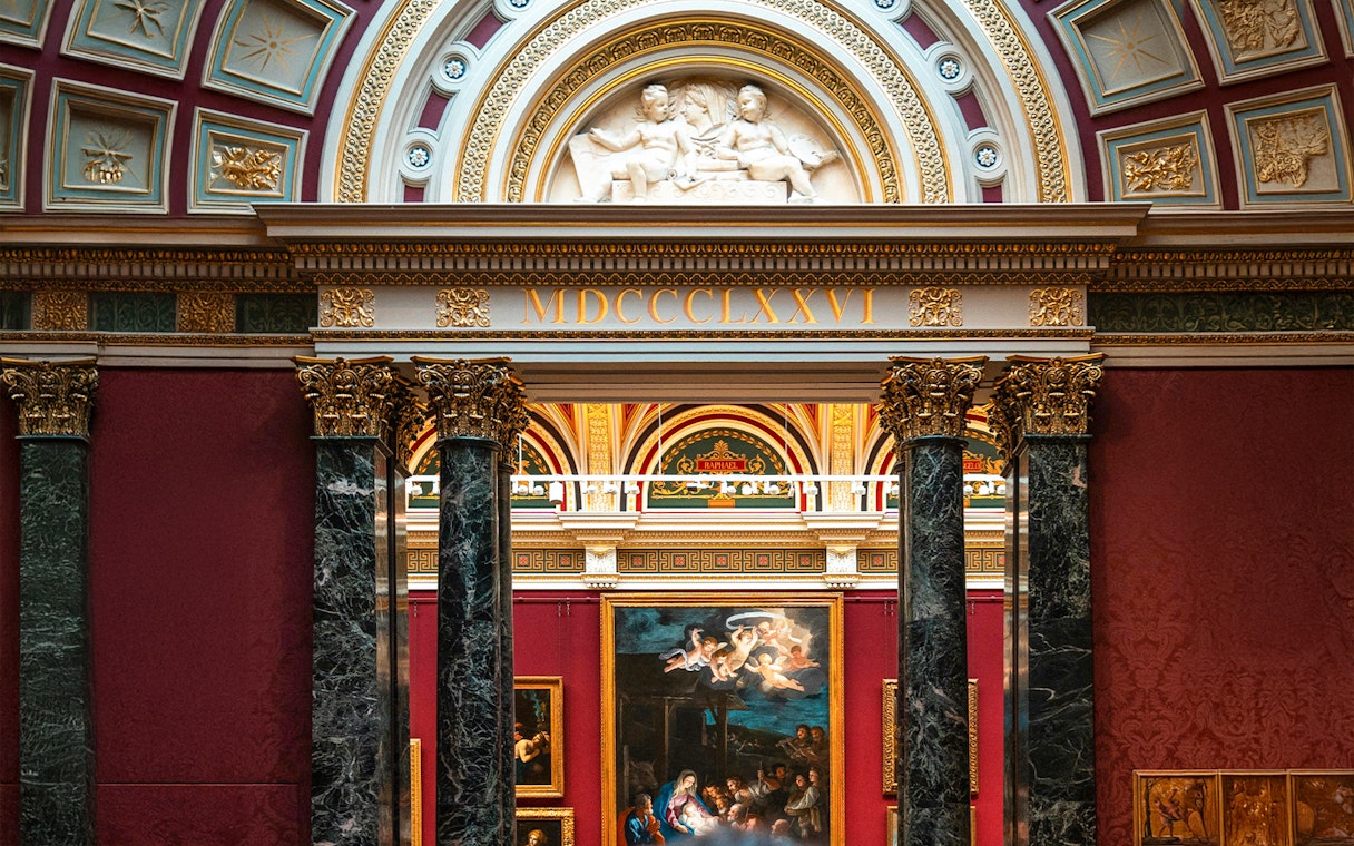 National Gallery London interior with classic European paintings and ornate architecture.