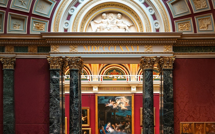 National Gallery London interior with classic European paintings and ornate architecture.