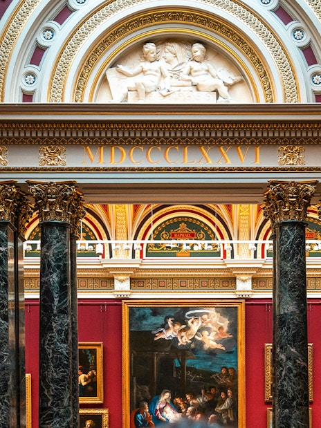 National Gallery London interior with classic European paintings and ornate architecture.